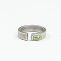 sterling silver open signet ring is hand forged and finished with an emerald-cut peridot stone