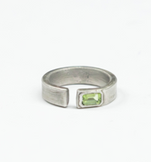 sterling silver open signet ring is hand forged and finished with an emerald-cut peridot stone