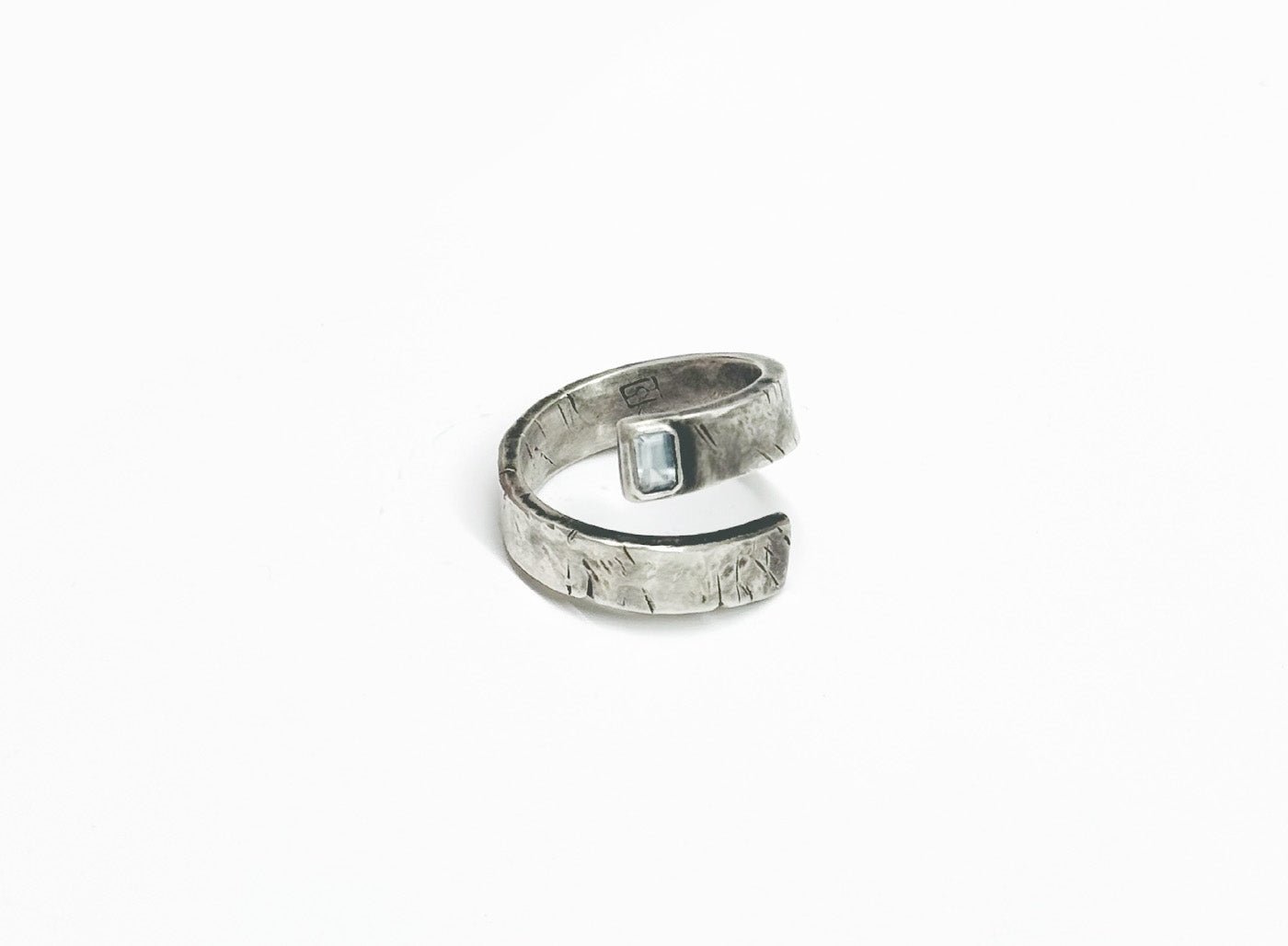 adjustable, open spiral ring features a 5mx3m emerald-cut aquamarine stone