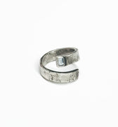 adjustable, open spiral ring features a 5mx3m emerald-cut aquamarine stone