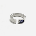 this open signet ring is hand forged and finished with an emerald-cut iolite gemstone