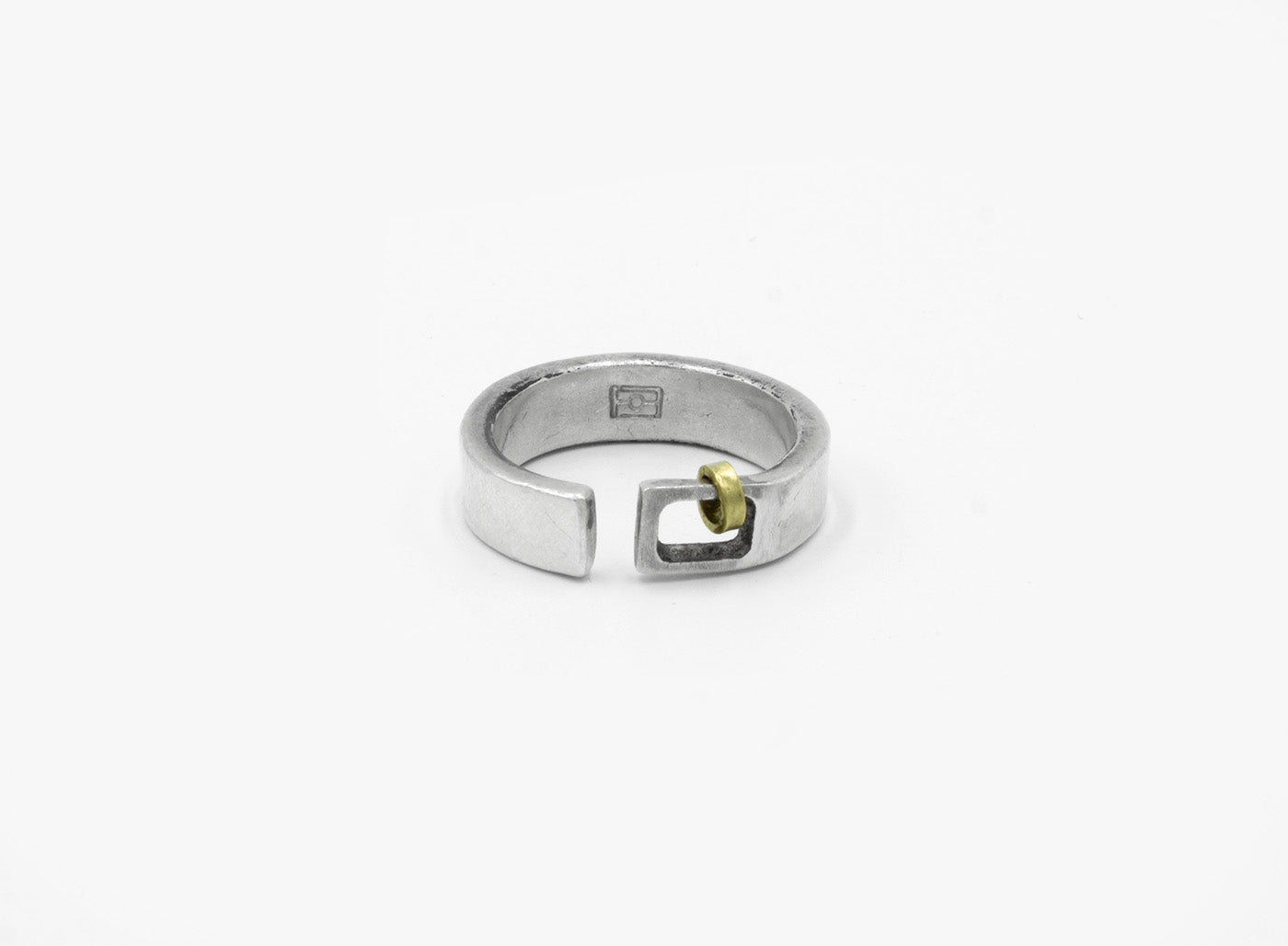 this adjustable, 6mm-wide hand-forged open sterling silver ring is accented with an 18k gold hoop
