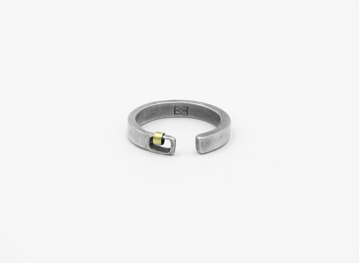 this adjustable, 5mm-wide hand-forged open sterling silver ring is accented with an 18k gold hoop