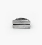 this distressed double bar ring features two wide, parallel sterling silver bands connected by a ruby accent. its rugged, hand-forged texture enhances the raw, sculptural feel of the design