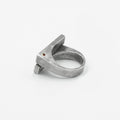 this distressed double bar ring features two wide, parallel sterling silver bands connected by a ruby accent. its rugged, hand-forged texture enhances the raw, sculptural feel of the design