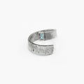 this adjustable, open spiral ring features a 7mm gemstone set within its rugged, distressed silver band. it is hand forged and distressed for a 'worn in' look