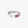 this open signet ring is finished with an emerald-cut garnet stone. it is constructed in our lower east side studio using reclaimed sterling silver and conflict-free gem stones