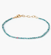 adjustable bracelet features 2mm blue diamonds that are finished with an 18k gold cable chain and our signature singular ruby