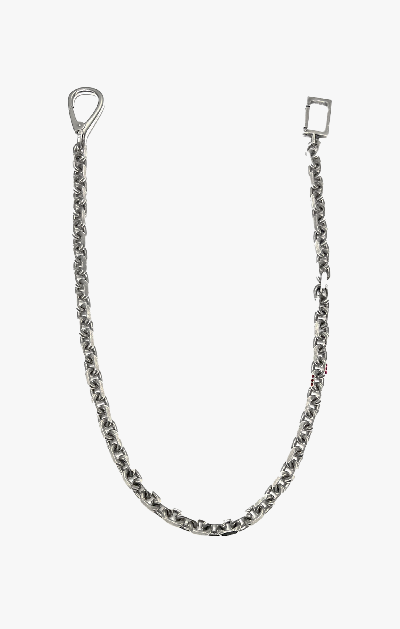 this wallet chain is composed of oversized cable links, 12 inset red rubies on two of the links add a discreet yet luxurious touch of brilliance, finished with a custom rectangular clasp that attaches to your belt loop.