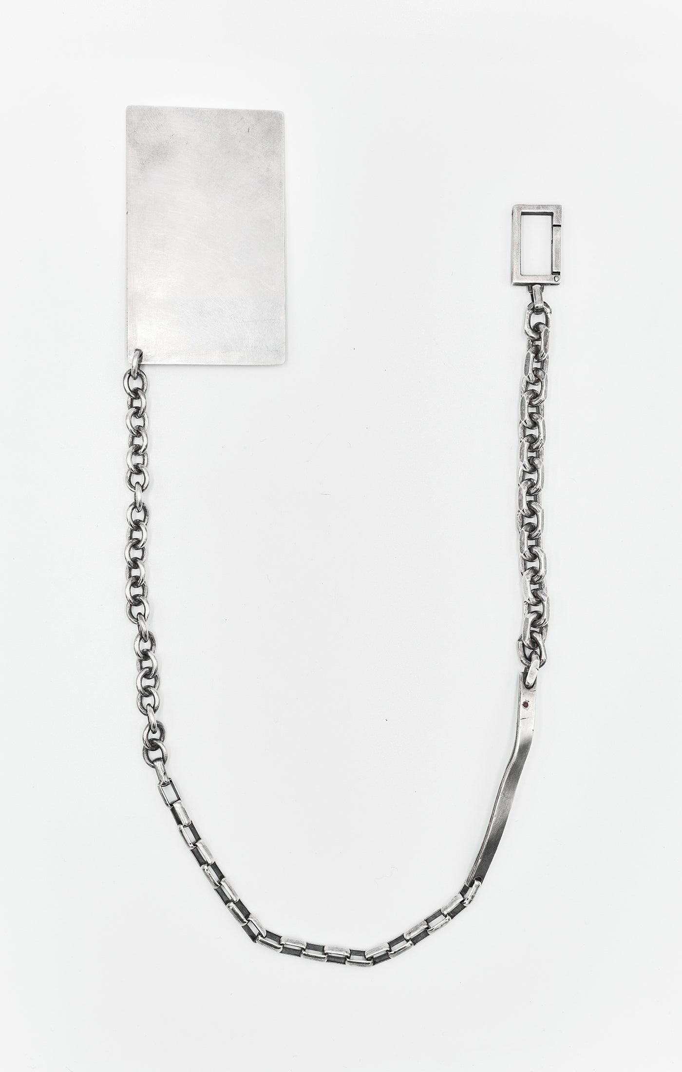 this wallet chain is composed of mixed cable, round, and box chains, a silver bar with an inset ruby, and finished with a custom box clasp. it attaches to a solid sterling silver credit card that fits in any standard wallet.