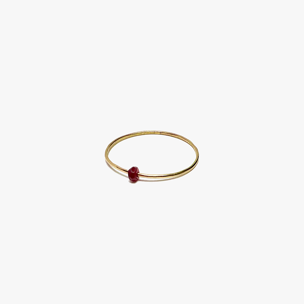 this delicate 18k gold ring features a single ruby.