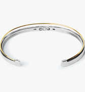 dual bracelet features an 18k gold wire that sits along a sterling cuff