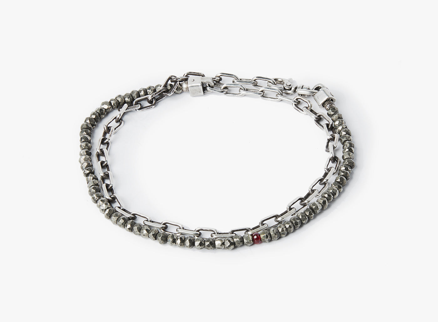 adjustable double wrap bracelet features a strand of pyrite stones that are disrupted by our signature ruby, and connects to an anchor chain