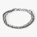 adjustable double wrap bracelet features a strand of pyrite stones that&nbsp; are disrupted by our signature ruby, and connects to an anchor chain