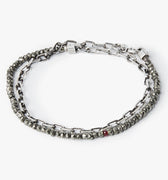 adjustable double wrap bracelet features a strand of pyrite stones that&nbsp; are disrupted by our signature ruby, and connects to an anchor chain