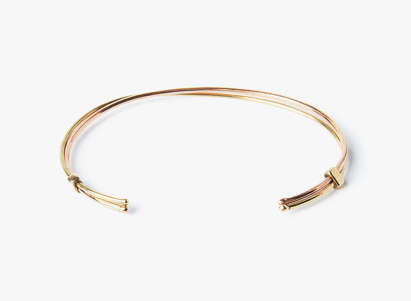 18K SOLID GOLD BRACELET 235: these 15GA, 18K yellow gold and rose gold cuffs are connected by a gold link