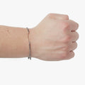 adjustable micro cable chain connects to a hand forged 18K gold bar