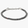 adjustable hematite stone bracelet is finished with a signature single ruby