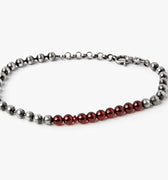 adjustable bracelet features a a sterling ball chain that connects to a 1.5" strand of 3mm garnet beads and finished with a single ruby