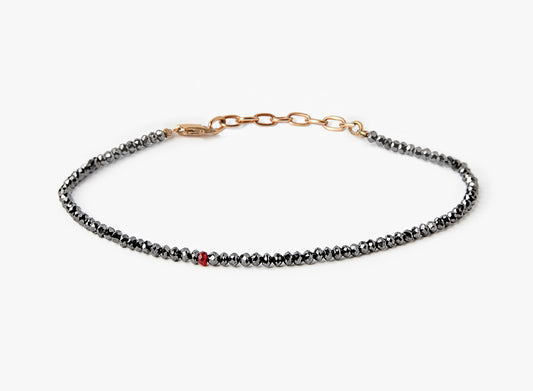 BEADED STONES BLACK DIAMOND BRACELET 313: this adjustable black diamond bracelet is finished with an 18k gold anchor chain and a single ruby