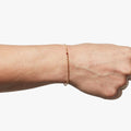 18K SOLID BAR W/ RUBY BRACELET 357: an 18k gold bar connects to a single red ruby and an 18k gold ball chain