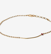 18K SOLID BAR W/ RUBY BRACELET 357: an 18k gold bar connects to a single red ruby and an 18k gold ball chain