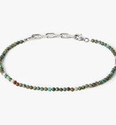 adjustable african turquoise stone bracelet is finished with a signature single ruby