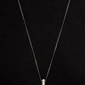 2" solid sterling rod hangs from a 28" curb chain and is finished with a thumbprint detail