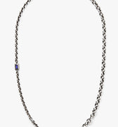 sterling necklace features an emerald cut iolite stone that sits along varying cable chains