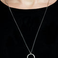 a sterling silver ring hangs from a 28" curb chain 