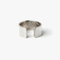 12.5mm x 1.25mm adjustable, open ended ring is hand forged in our lower east side studio using reclaimed sterling silver, which is then oxidized - resulting in a darkened finish that will wear over time to a lighter, contrasting patina