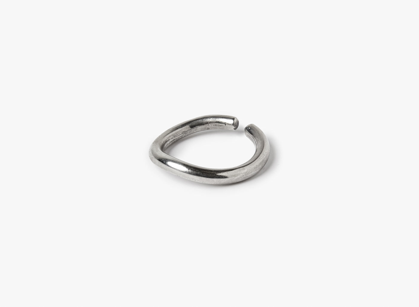 adjustable sterling open-ended ring is hand forged in our lower east side studio. it is made from reclaimed sterling silver, which is then oxidized - resulting in a darkened finish that will wear over time to a lighter, contrasting patina