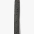 This image displays the ASYMMETRICAL COIL NECKTIE 1008, a stylish accessory crafted from imported Italian wool. The necktie features a sophisticated geometric pattern, adorned with asymmetrically hand-threaded coils in a subtle black and ivory color scheme.