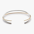 hinged cuff is made with 18k yellow gold  sterling silver