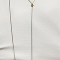 18k gold cable chain connects to a double wrap sterling bead chain and is finished with a thumbprint detail