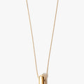 one inch solid 18k gold rod suspends from an ball chain disrupted by a solid bar