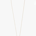 one inch solid 18k gold rod suspends from an ball chain disrupted by a solid bar