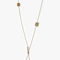 lariat necklace features a series of 5x3 mm and 6x4mm emerald-cut gemstones that pivot within frames on an 18k ball chain